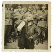 German coastal Kriegsmarine soldiers coerced  loclchildren to drink the alcohol and smoke the cigarette